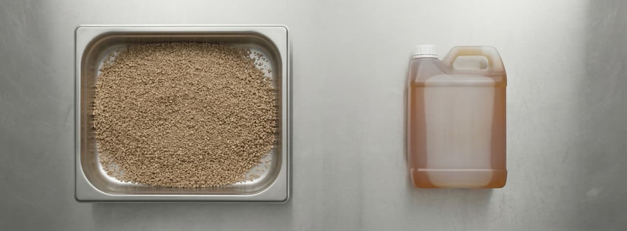 Overhead flat-lay of dry granular sterile compost and liquid fertiliser output from the PHANTOM subcritical water hydrolysis process — the reusable recovered materials produced from livestock waste, fishery residues, food processing waste, and mixed organics in 30 minutes.