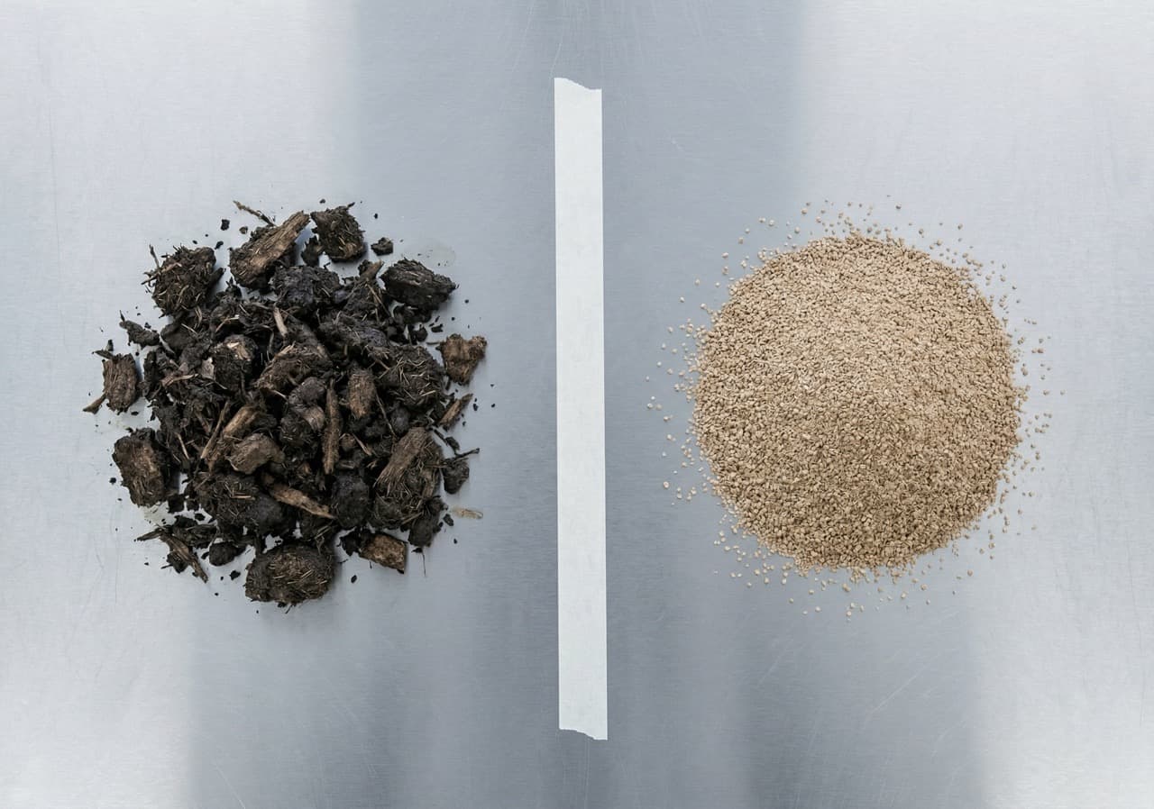 Overhead flat-lay comparison of traditional compost output (dark, irregular, fibrous texture, left) versus Phantom subcritical hydrolysis sterile output (pale brown, uniform fine granules, right) on a stainless steel surface under clinical lighting