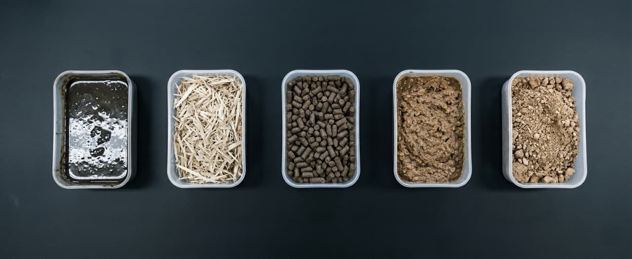 Overhead view of five livestock manure feedstock types — poultry, swine, cattle, horse, sheep — showing visual differences in moisture and composition for organic fertilizer production